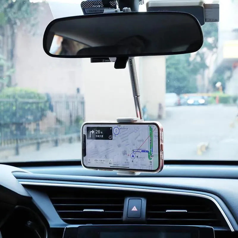 Black mobile phone bracket mounted on car rearview mirror holding smartphone