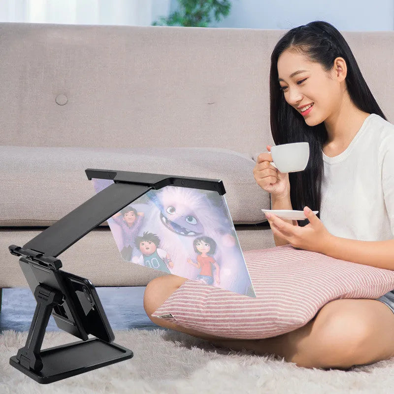 Black 12-inch split-screen mobile phone magnifier with acrylic lens and ABS plastic bracket on a table
