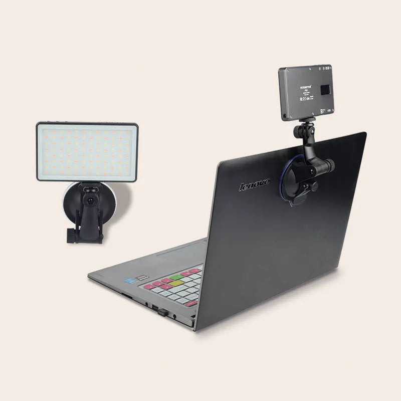 Black aluminium LED conference light with 96 LEDs, measuring 116mm wide, beside a laptop