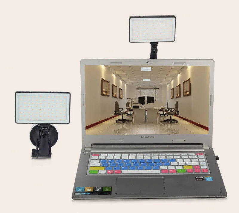 Black aluminium LED conference light with 96 LEDs, measuring 116mm wide, beside a laptop