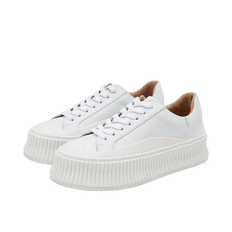 Women's thick bottom platform sneakers with suede leather, cross binding lacing, and muffin heel design in white colour