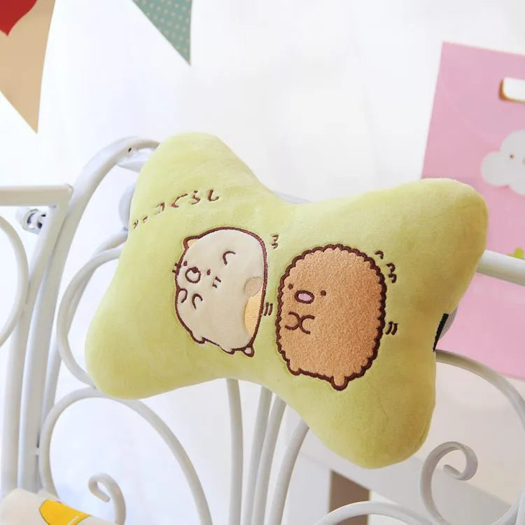 Plush car headrest neck pillow in green and beige with matching safety belt covers and cartoon pattern