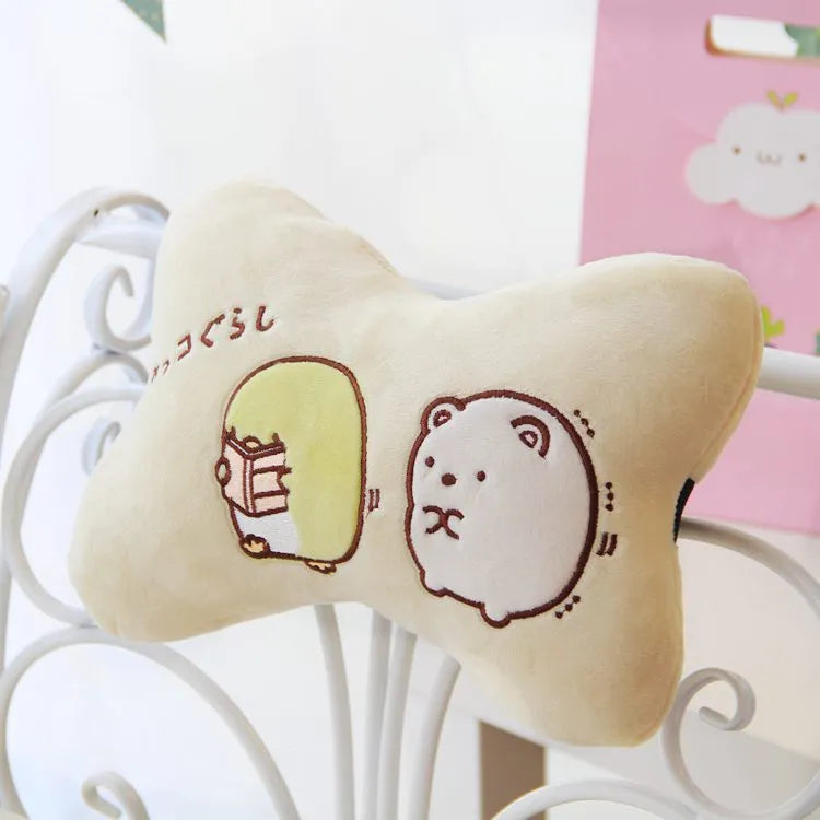Plush car headrest neck pillow in green and beige with matching safety belt covers and cartoon pattern