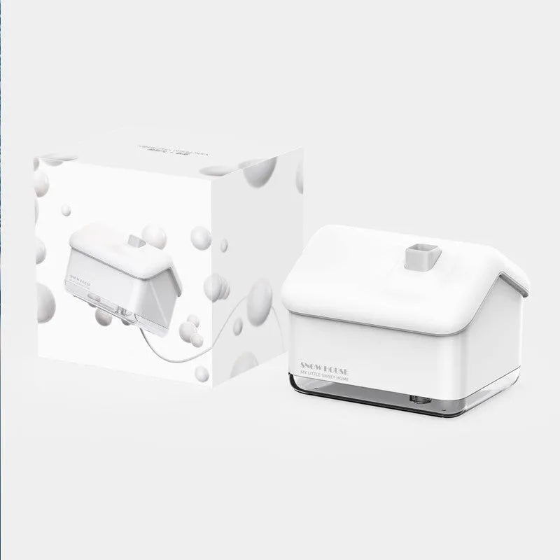 White igloo-shaped ultrasonic humidifier and essential oil diffuser with LED light on a table.