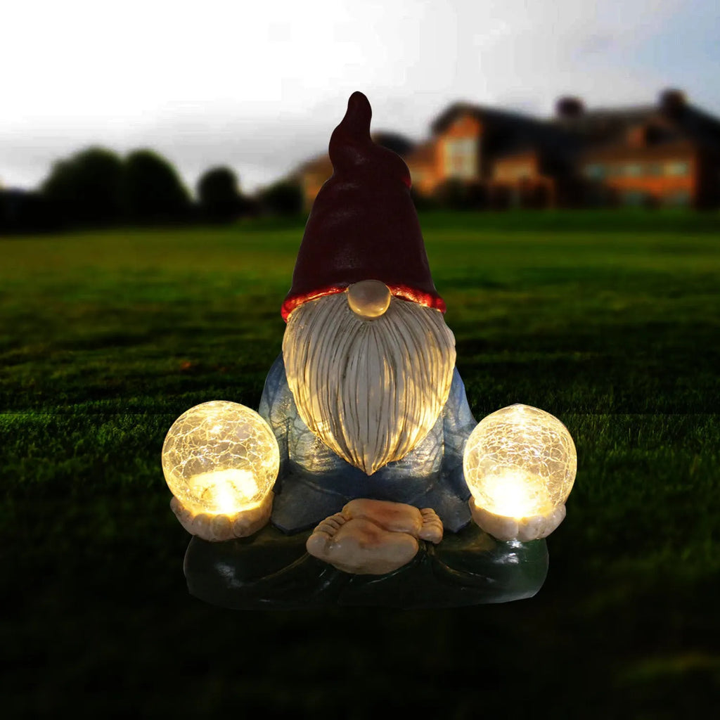 Solar LED resin dwarf doll garden ornament with 'Faceless Old Man' design on grass.