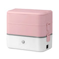 Pink and white portable electric lunch box with push buttons and stainless steel interior.