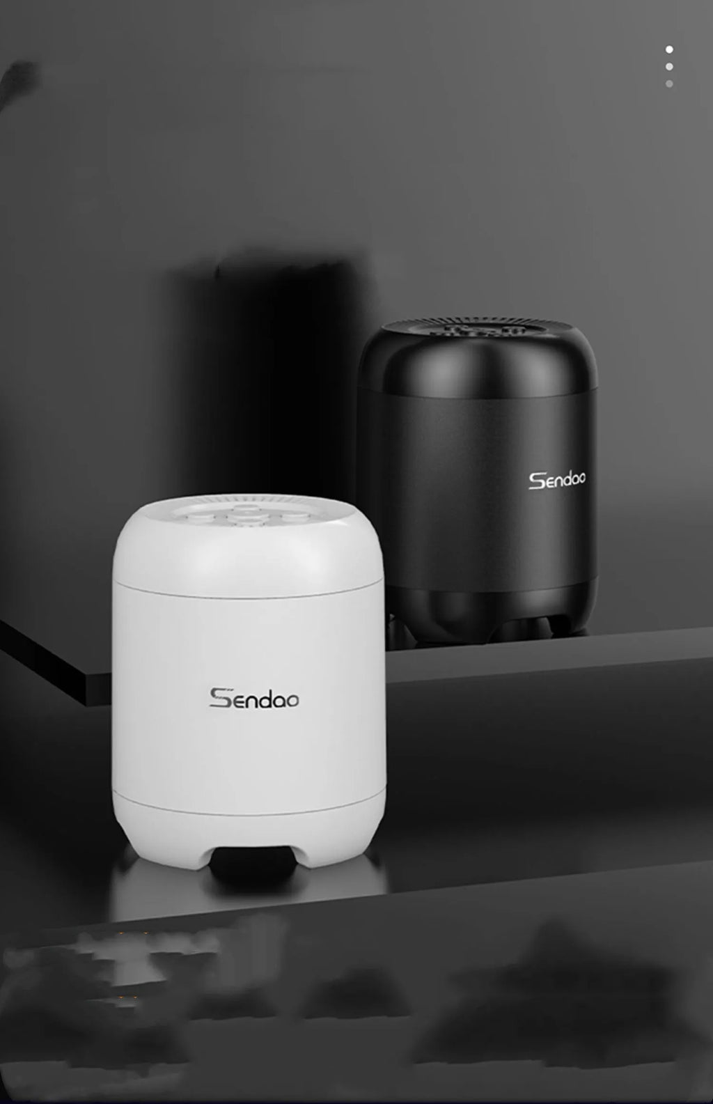 Compact black or white wireless Bluetooth speaker with card reader slot and USB port.
