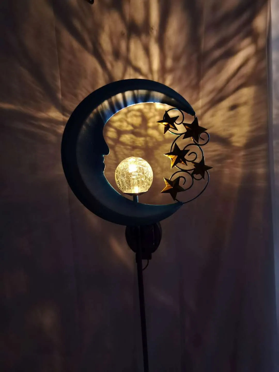 Blue moon shaped solar lawn light with wrought iron frame and crack glass ball LED