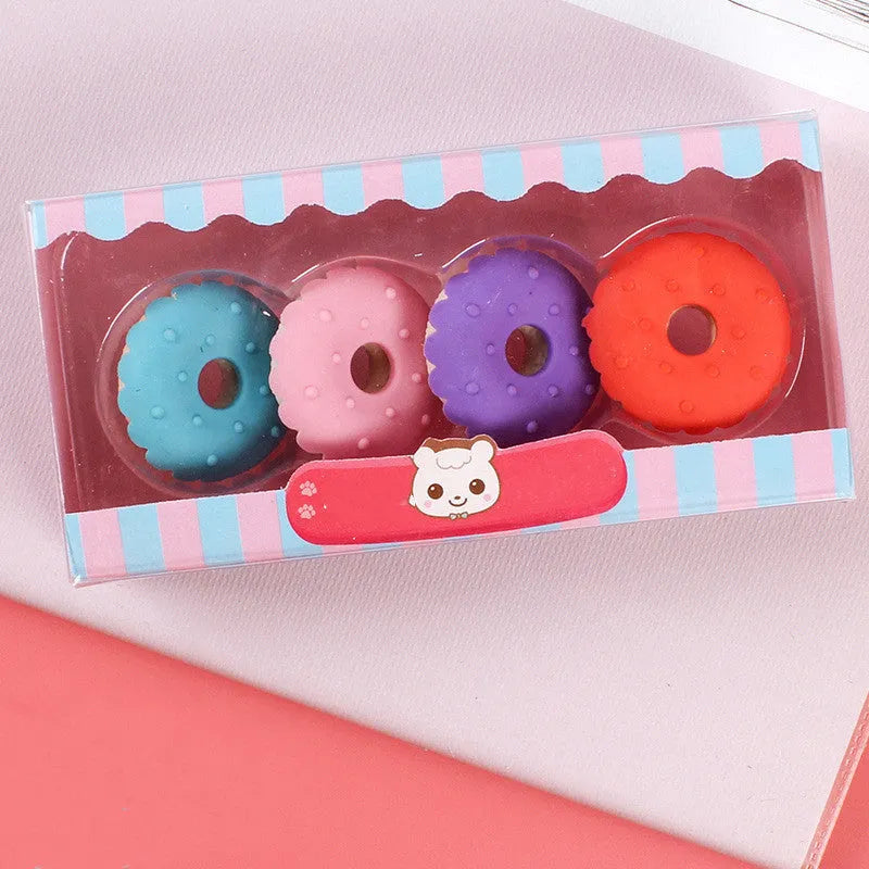Cartoon eraser set with 12 character shapes including ice cream cones, doughnuts, and lollipops for children