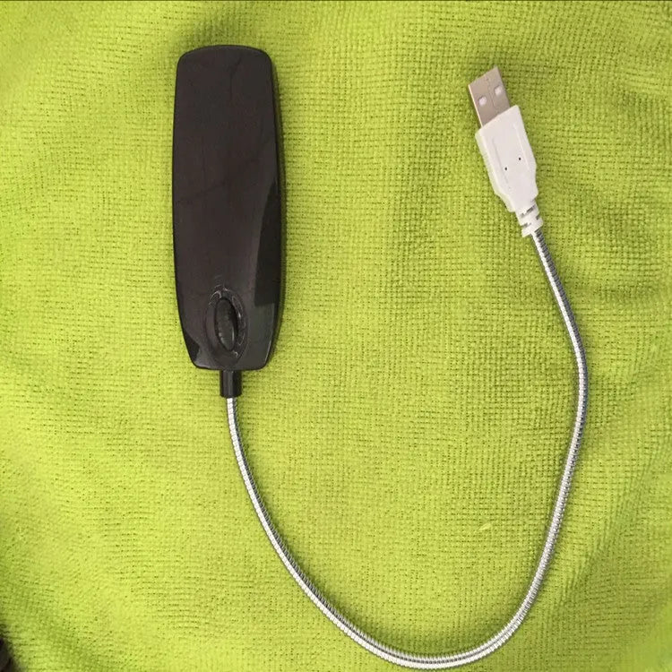 Flexible neck USB LED lamp bent over a book, showing black, white, blue, and pink colour options.