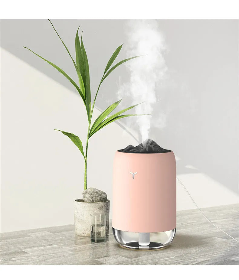 Magic Flame columnar humidifier in light blue colour on desktop with USB cable