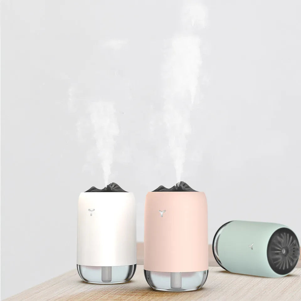 Magic Flame columnar humidifier in light blue colour on desktop with USB cable