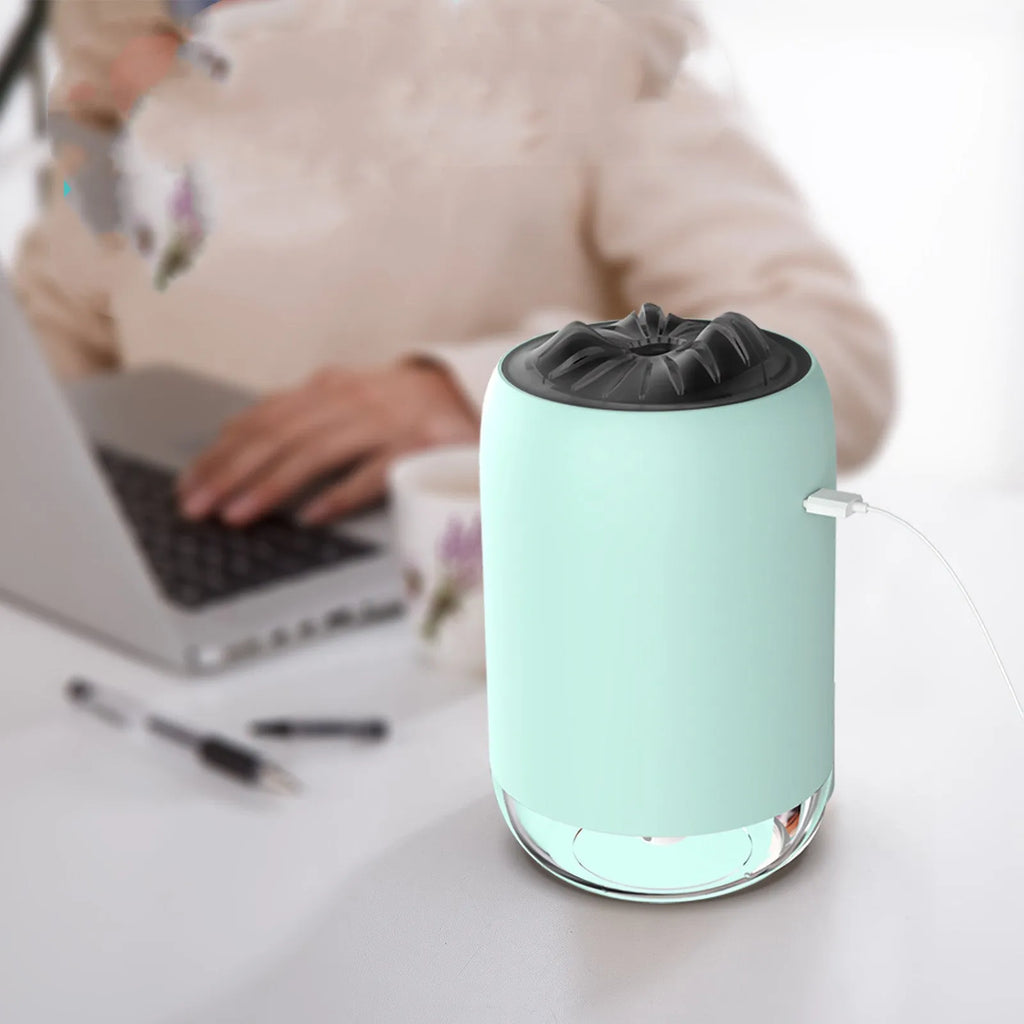 Magic Flame columnar humidifier in light blue colour on desktop with USB cable