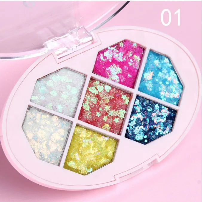 Small pot of glitter eye shadow gel cream with shimmer sequins in seven colour options for face and body festival use