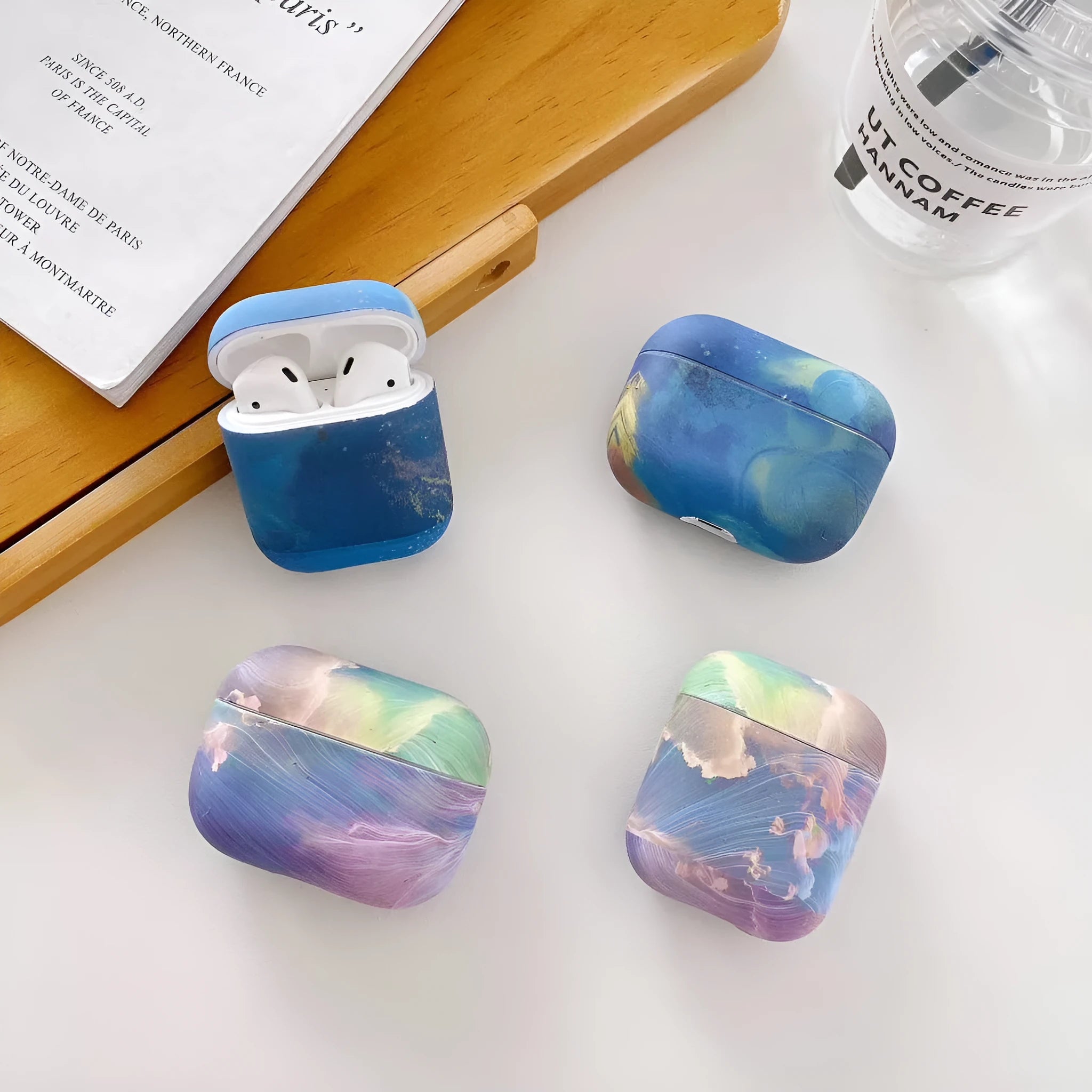 Hard shell plastic protective case for Apple AirPods with watercolour design in pink and blue options