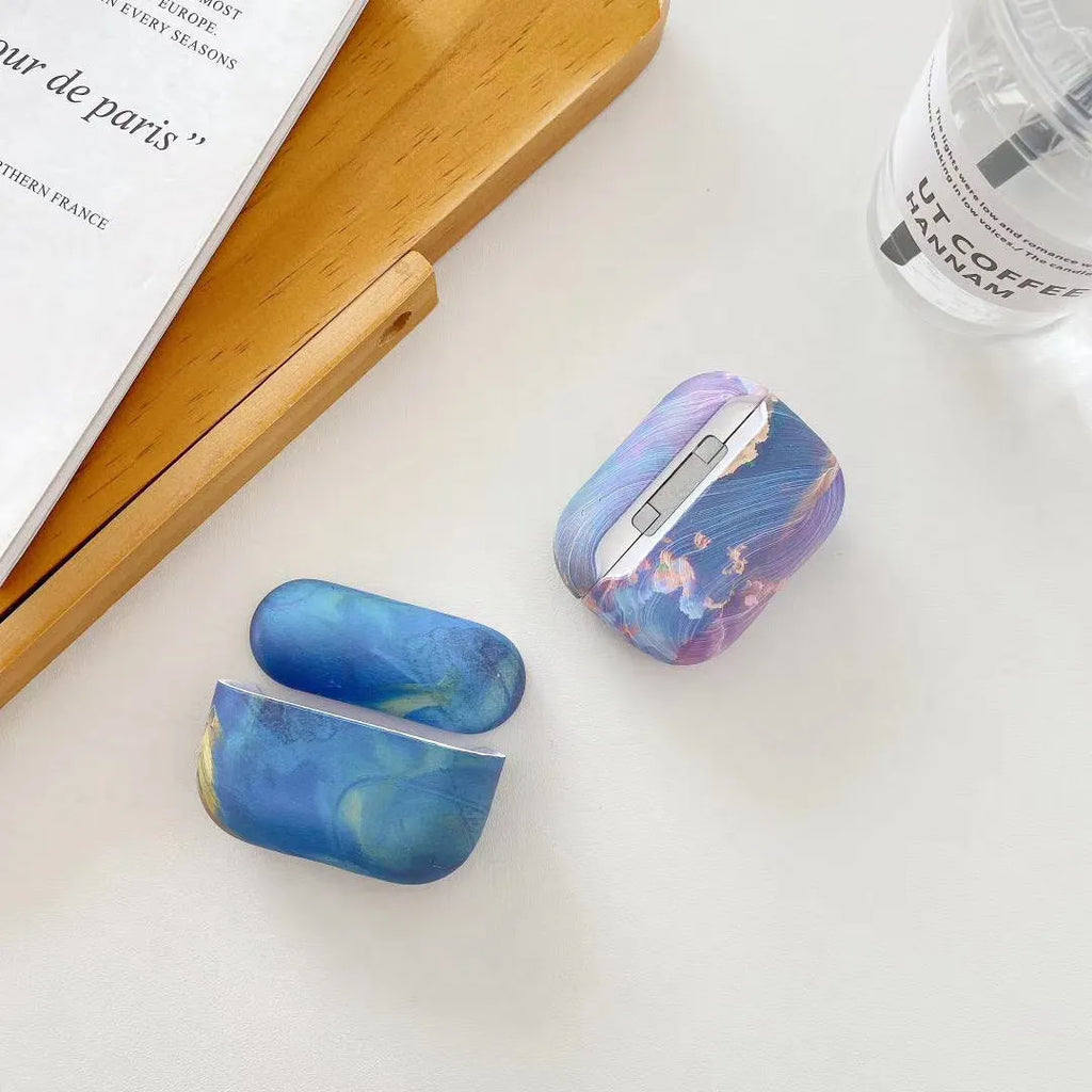 Hard shell plastic protective case for Apple AirPods with watercolour design in pink and blue options