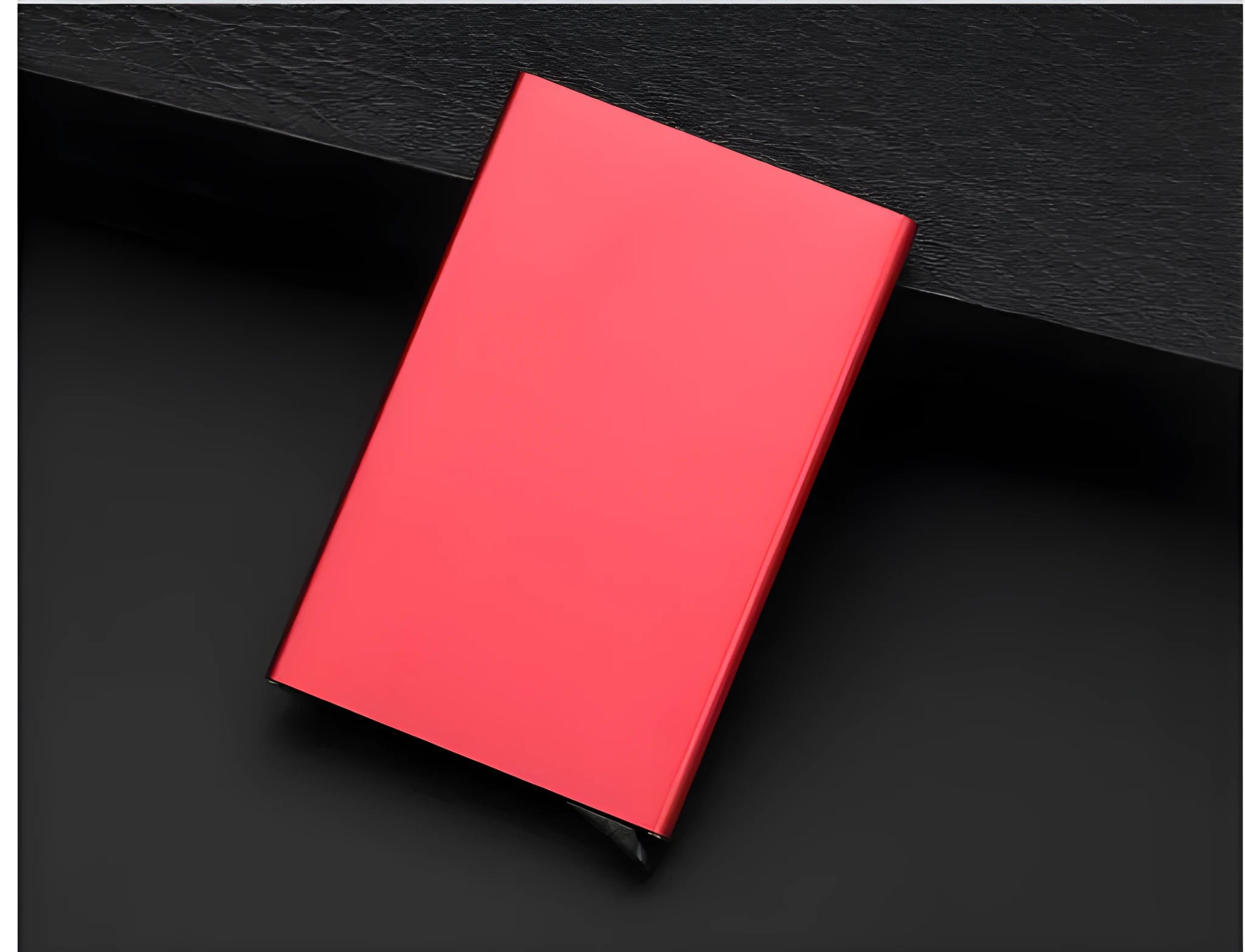 Aluminium alloy geometric business card holder in silver, 9.5 cm high, on a desk