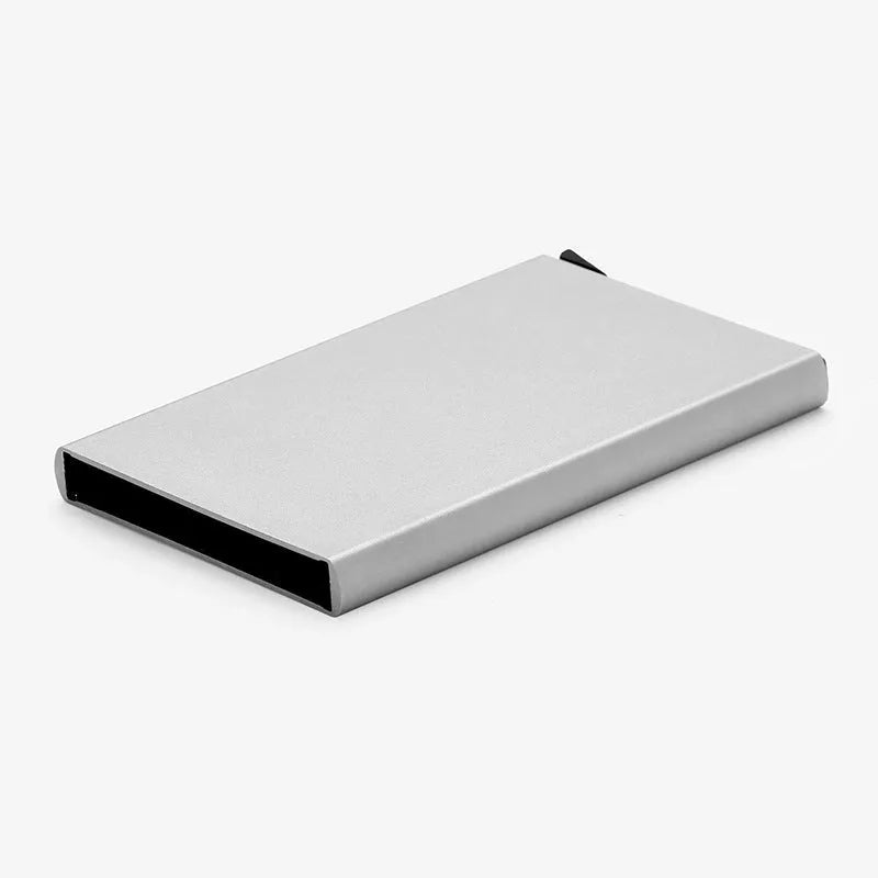 Aluminium alloy geometric business card holder in silver, 9.5 cm high, on a desk