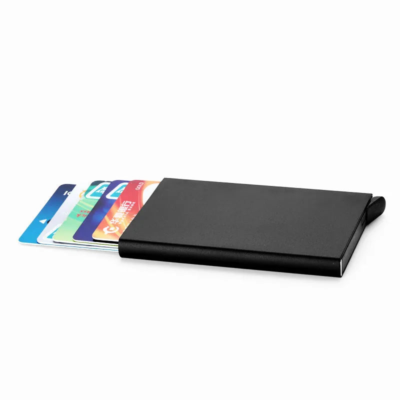 Aluminium alloy geometric business card holder in silver, 9.5 cm high, on a desk