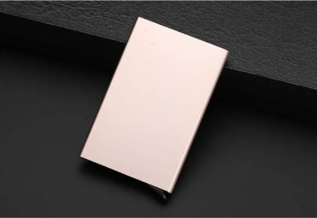 Aluminium alloy geometric business card holder in silver, 9.5 cm high, on a desk