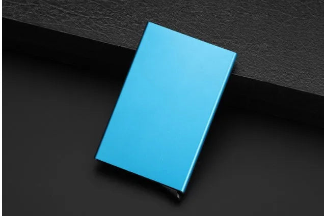 Aluminium alloy geometric business card holder in silver, 9.5 cm high, on a desk