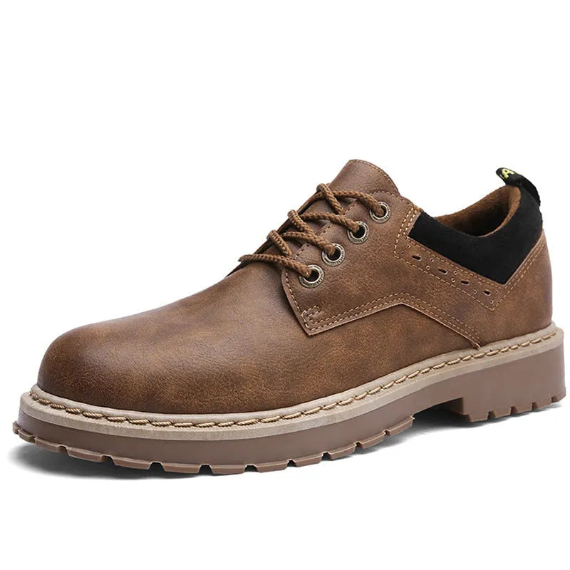 Men's black casual shoes with round toe, flat heel, and front lace-up design on a plain background.