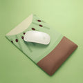 Pink and white cute creative girl design silicone wrist mouse pad on a desk.