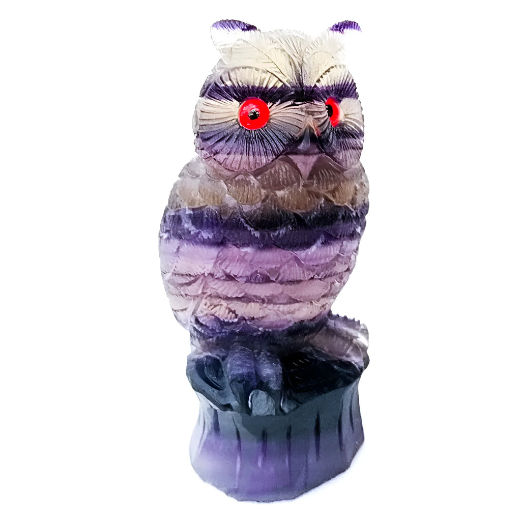 Purple fluorite hand-carved owl ornament on a neutral background, showing natural stone colour and carving detail.