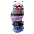 Purple fluorite hand-carved owl ornament on a neutral background, showing natural stone colour and carving detail.