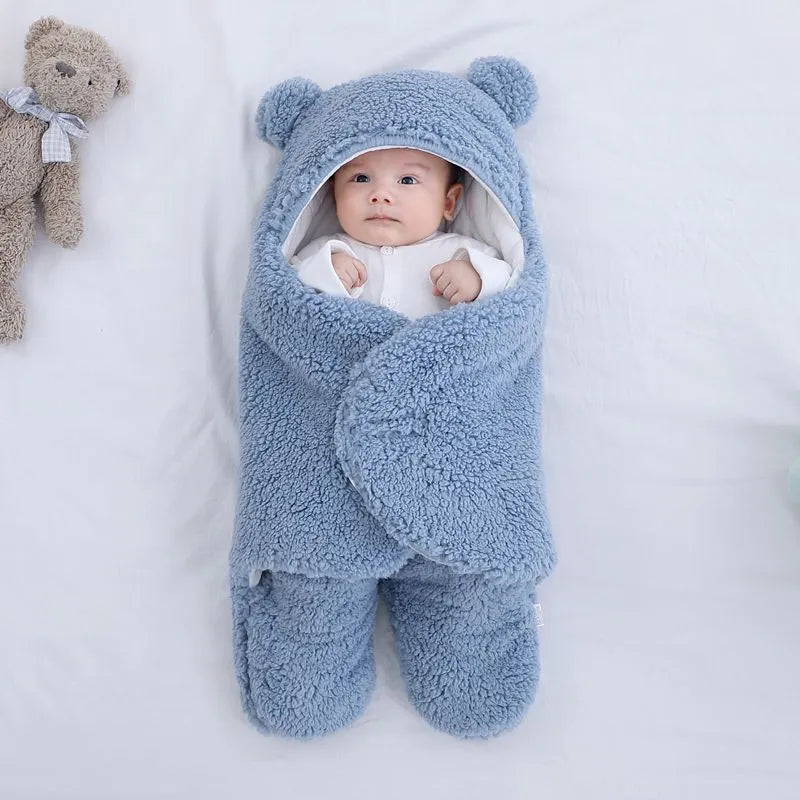 Baby quilted sleeping bag wrapper in a light blue colour showing its quilted pattern and size.