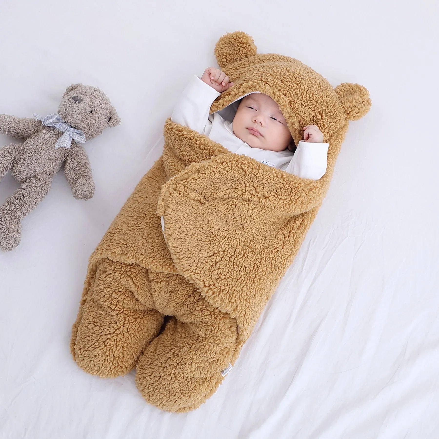 Baby quilted sleeping bag wrapper in a light blue colour showing its quilted pattern and size.
