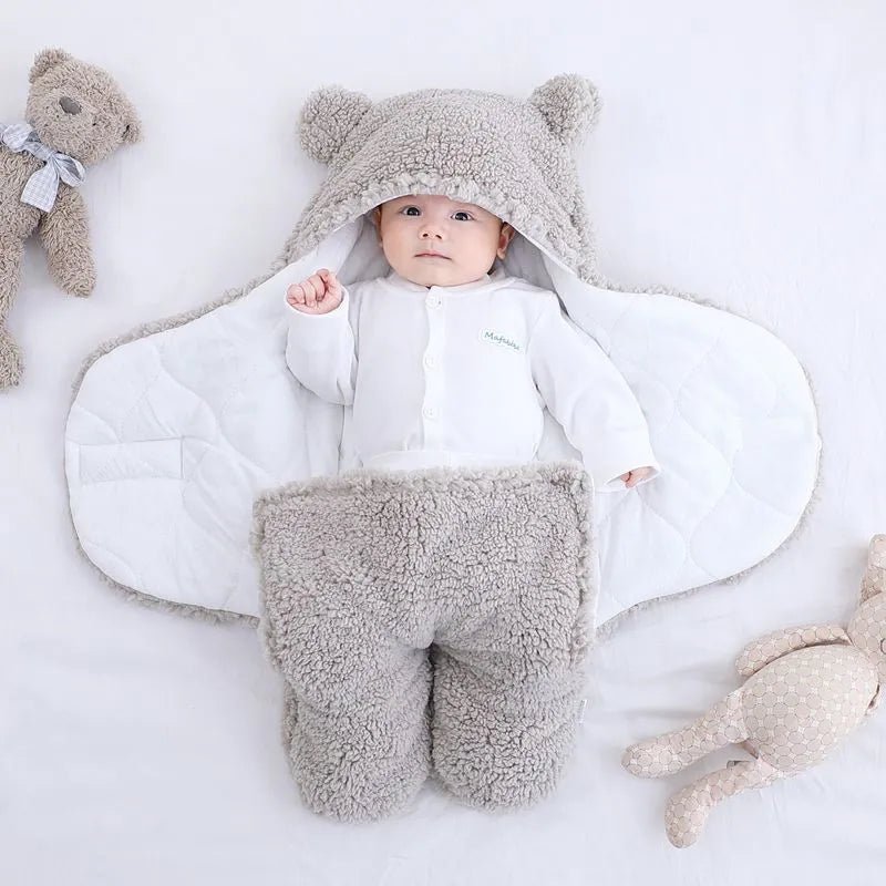 Baby quilted sleeping bag wrapper in a light blue colour showing its quilted pattern and size.