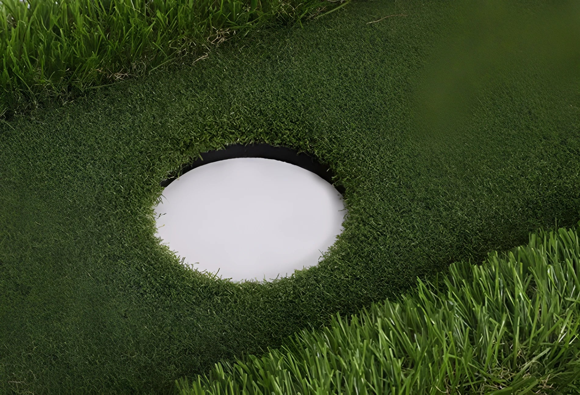Green golf training mat on a flat surface showing PP grass texture and EVA base.