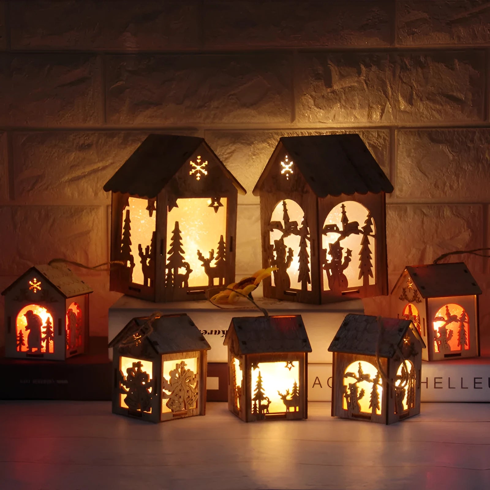 Three rustic wooden Christmas decorations including log bell, Santa Claus house, and snowman house on natural wood background