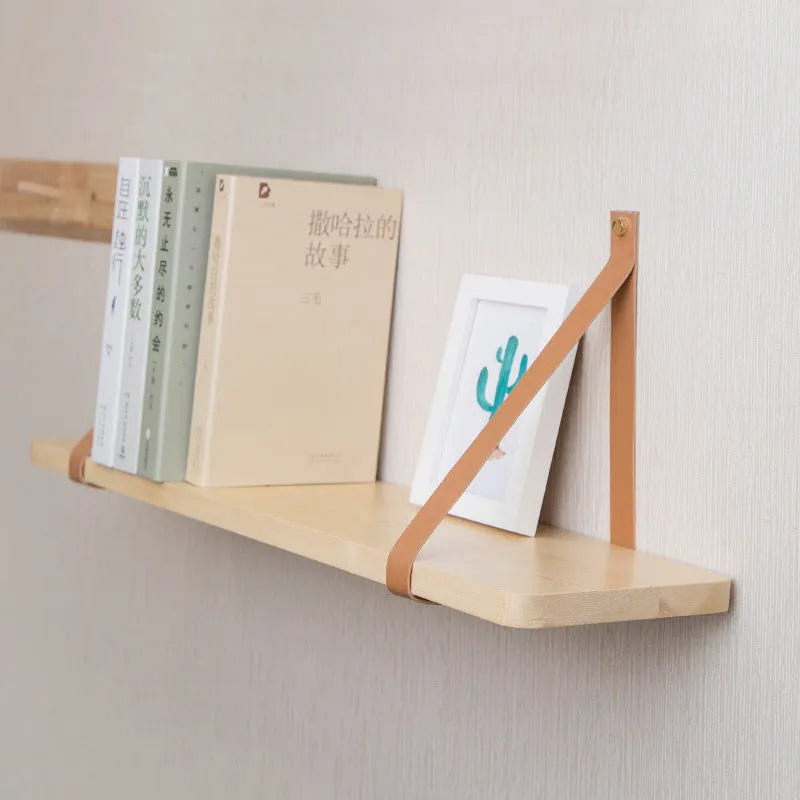 Nordic style pine wood wall mounted storage shelf for remote controls and small items.