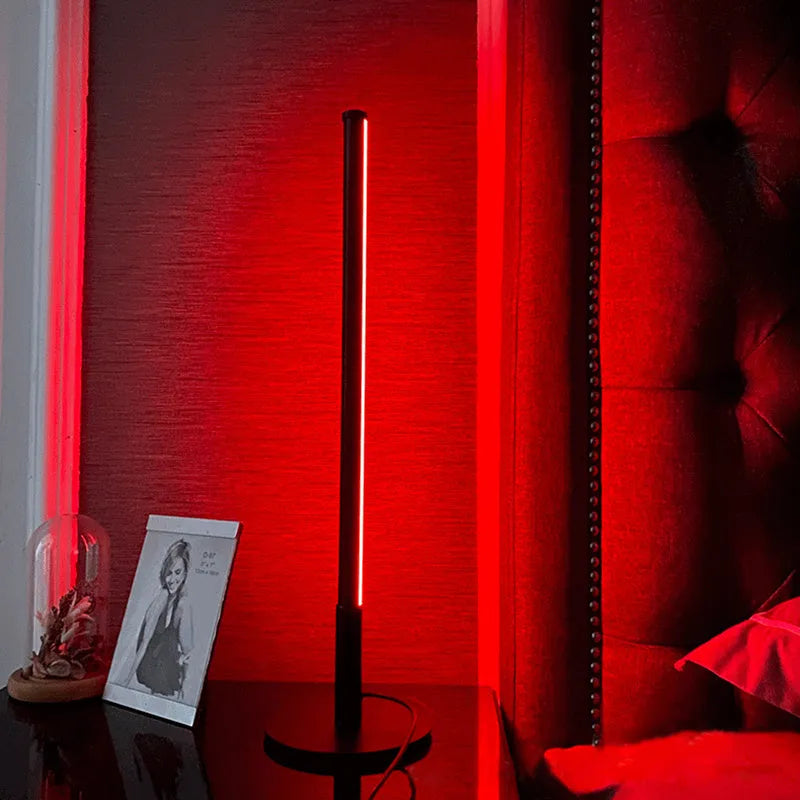 Black Nordic minimalist LED bedside lamp with RGB lighting and remote control on table
