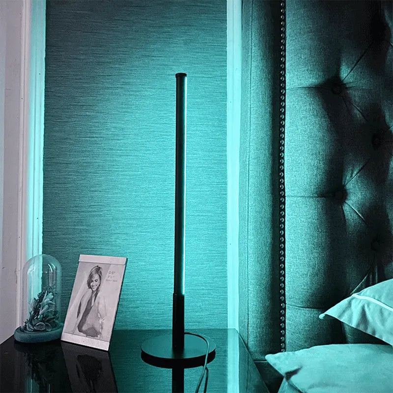 Black Nordic minimalist LED bedside lamp with RGB lighting and remote control on table