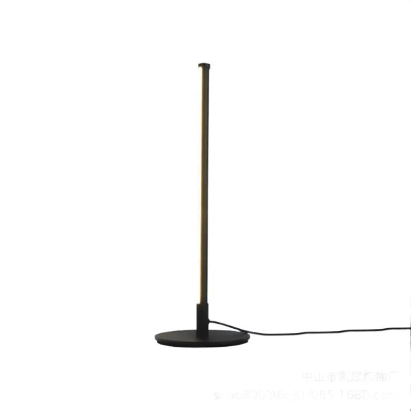 Black Nordic minimalist LED bedside lamp with RGB lighting and remote control on table