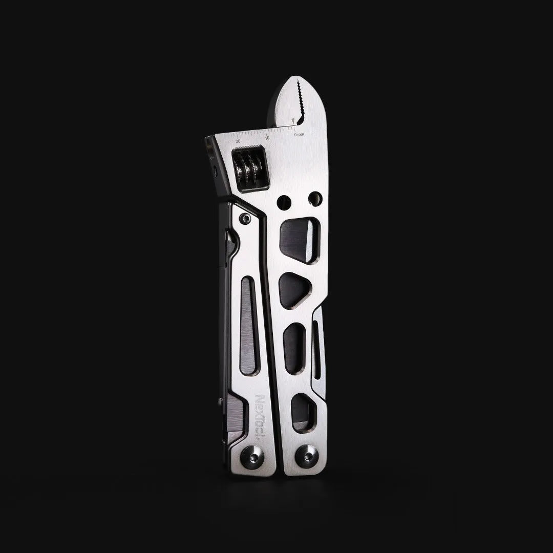 White stainless steel multi-function tool with wrench, knife, and needle nose pliers on a 13 cm handle.