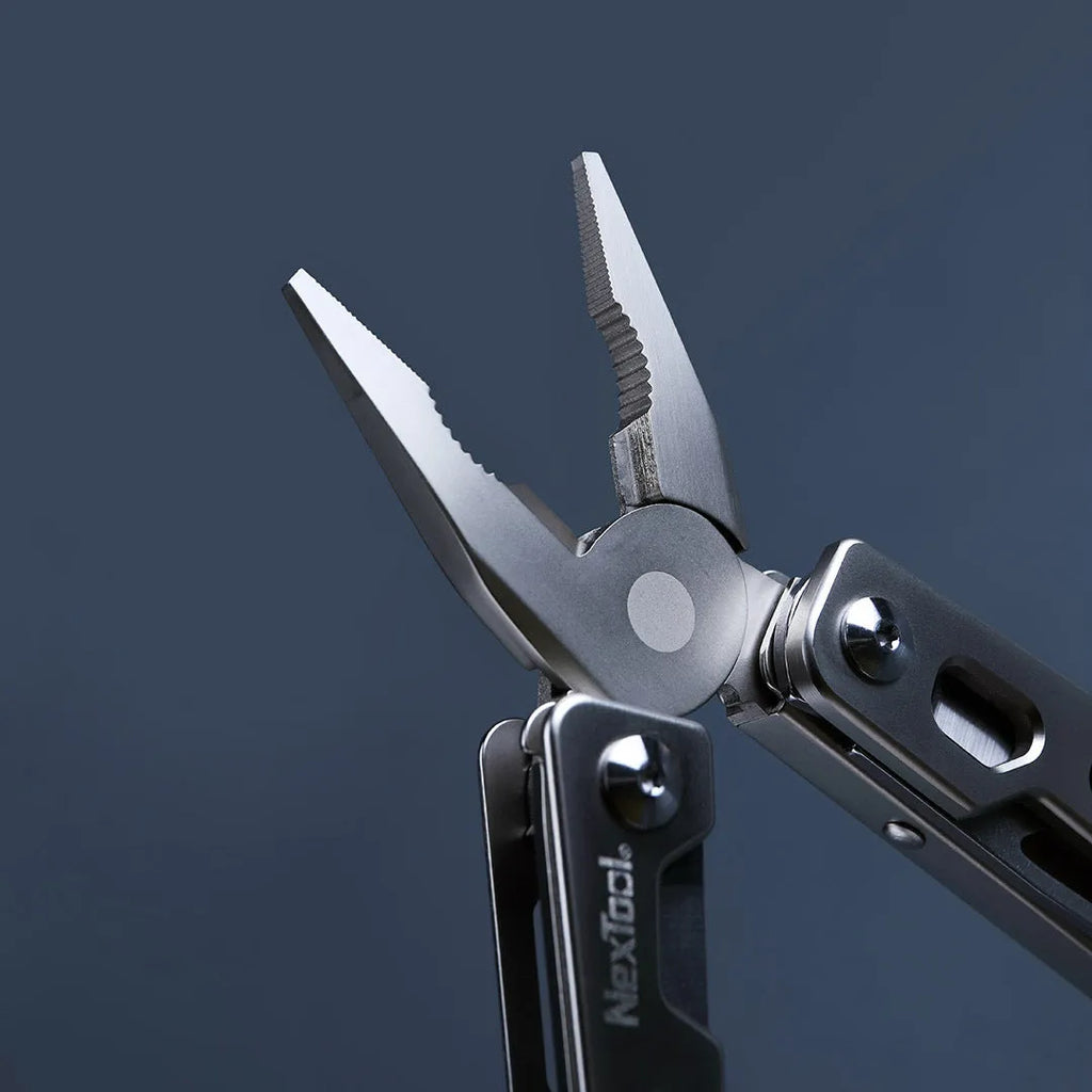 White stainless steel multi-function tool with wrench, knife, and needle nose pliers on a 13 cm handle.