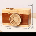 Wooden music box with a rotating camera design on a pine wood base.