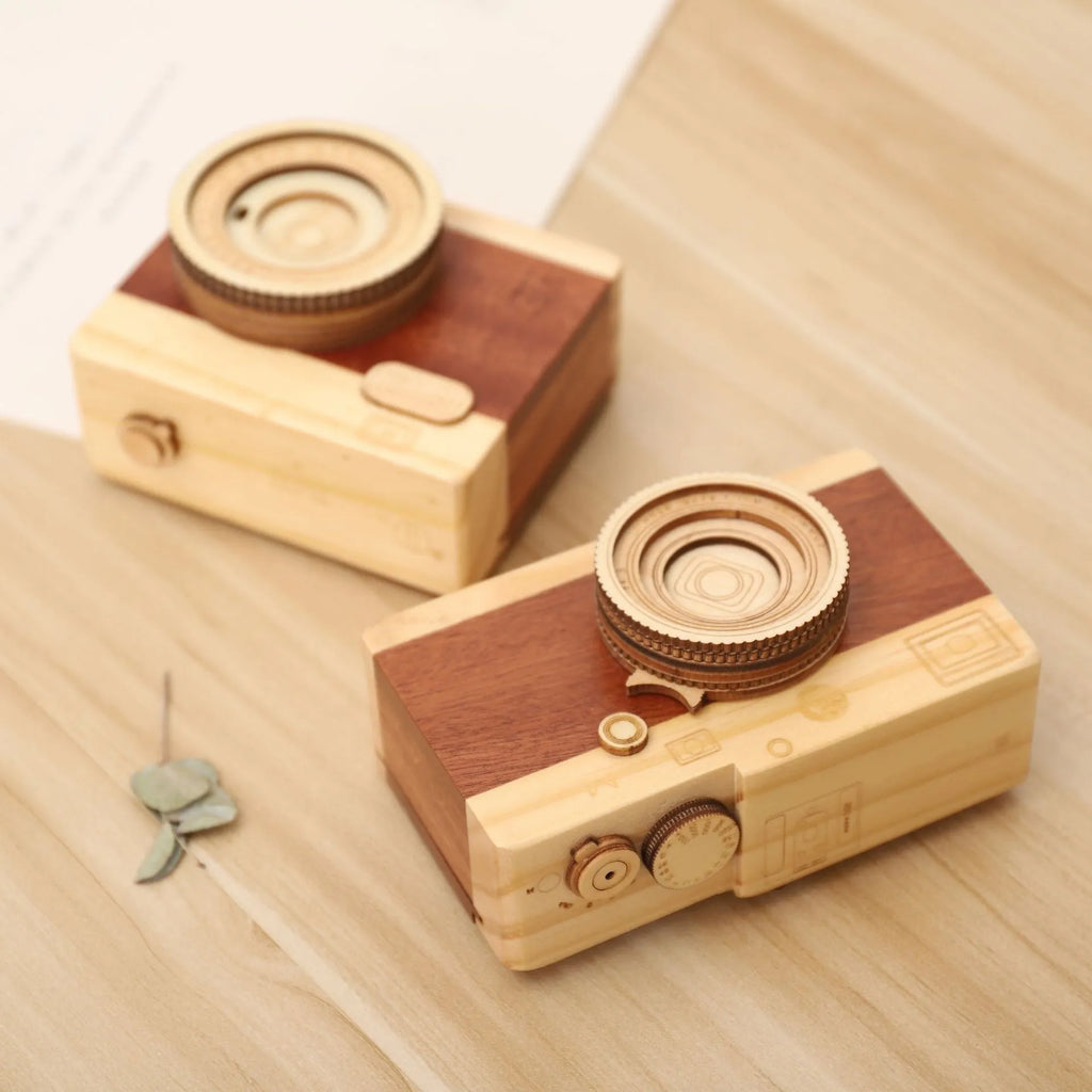 Wooden music box with a rotating camera design on a pine wood base.