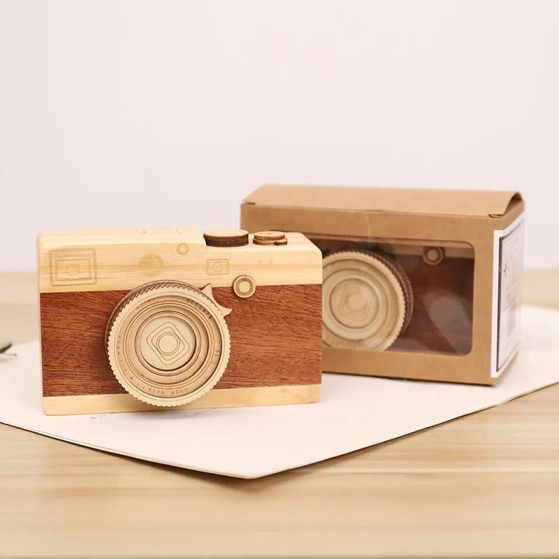 Wooden music box with a rotating camera design on a pine wood base.