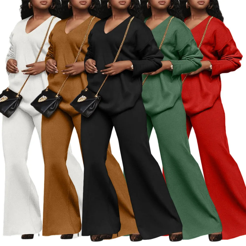 Women's brown suede two-piece casual suit with long sleeves and trousers on a hanger