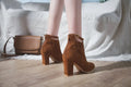 Women's high-heeled Martin boots with belt buckle detail, low tube, round toe, PU insole, available in black, apricot, brown.
