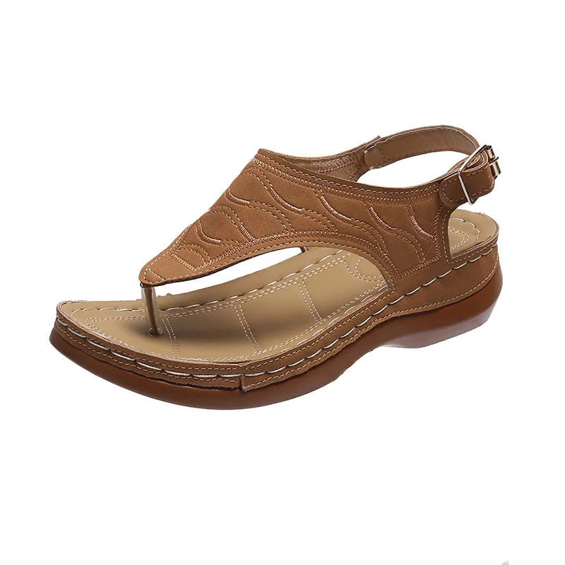Women's red wedge heel sandals with an adjustable buckle strap on a white background