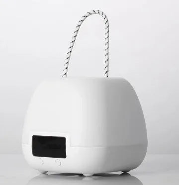 White rechargeable remote control night light on a bedside table with projection mode on