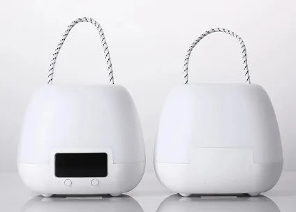 White rechargeable remote control night light on a bedside table with projection mode on