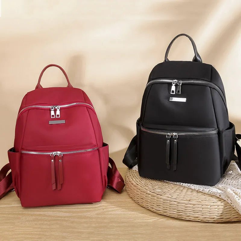 Women's medium Oxford cloth backpack in black with double straps and nylon fabric texture