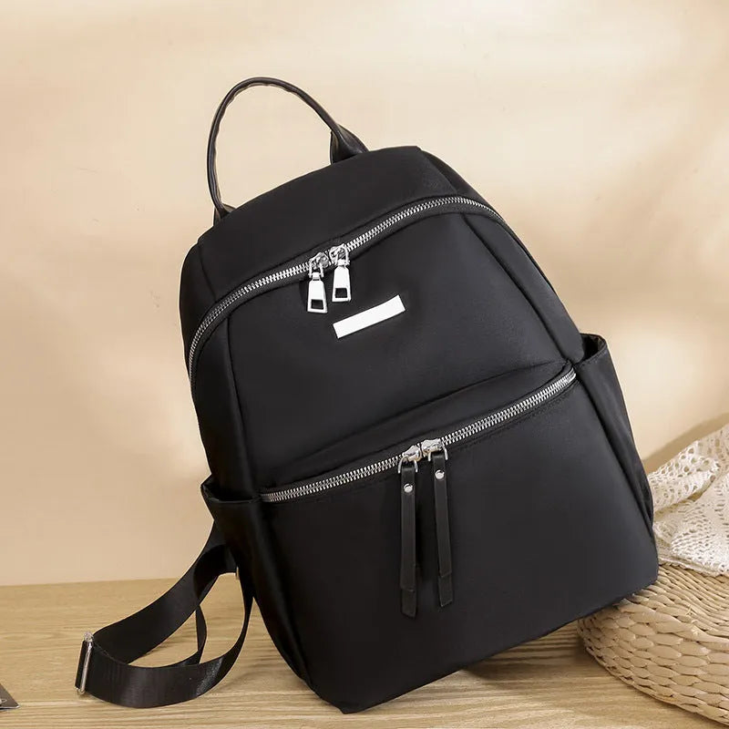Women's medium Oxford cloth backpack in black with double straps and nylon fabric texture